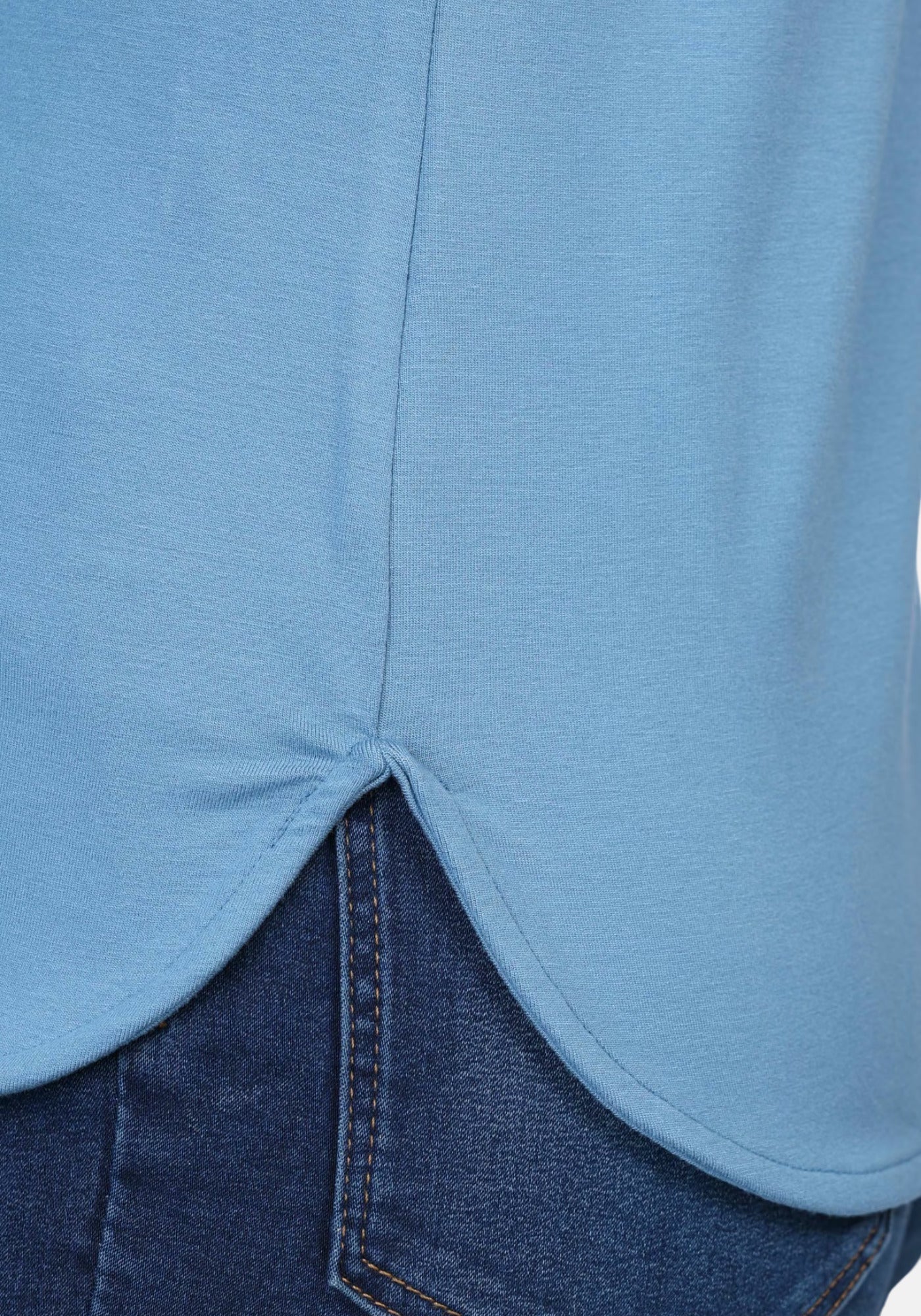 Detailansicht der abgerundeten Saumkante beim T-Shirt „Betzi“ in Schwedischblau, mit mittiger Naht am Rücken und hochwertiger Verarbeitung.